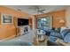 Cozy living room with balcony access, comfortable seating and bright, colorful décor at 6033 113Th St # 213, Seminole, FL 33772