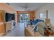 Relax in this inviting living room with balcony access, plenty of seating and colorful décor at 6033 113Th St # 213, Seminole, FL 33772