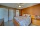 Inviting bedroom boasts a queen bed, ceiling fan, and access to an ensuite bathroom at 6033 113Th St # 213, Seminole, FL 33772