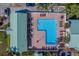 Aerial view of community pool surrounded by lounge chairs, tables, palm trees, and pavers at 6033 113Th St # 213, Seminole, FL 33772