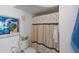 Well-lit bathroom with a shower curtain featuring seashells and a blue Hockney painting at 6083 Bahia Del Mar Cir # 359, St Petersburg, FL 33715