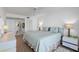 Cozy bedroom featuring a queen bed, closet, ensuite bathroom and light wood flooring at 6083 Bahia Del Mar Cir # 359, St Petersburg, FL 33715