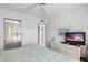 Bright bedroom featuring a TV, closet with mirrors and coastal decor at 6083 Bahia Del Mar Cir # 359, St Petersburg, FL 33715