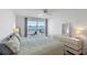 Bright bedroom featuring a balcony overlooking the water view, ceiling fan, and comfortable furnishings at 6083 Bahia Del Mar Cir # 359, St Petersburg, FL 33715