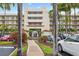 Beautiful five-story condo building featuring lush landscaping and a brick-paved walkway to the entrance at 6083 Bahia Del Mar Cir # 359, St Petersburg, FL 33715