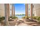 Picturesque courtyard with lush greenery, palm trees, and benches overlooking the tranquil waterfront at 6083 Bahia Del Mar Cir # 359, St Petersburg, FL 33715