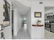 Bright hallway with white tile flooring, leading to the main living area and an adjacent modern kitchen at 6083 Bahia Del Mar Cir # 359, St Petersburg, FL 33715