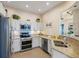 Modern kitchen featuring stainless steel appliances, granite countertops, and ample cabinet space at 6083 Bahia Del Mar Cir # 359, St Petersburg, FL 33715