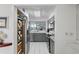 Modern kitchen with stainless steel appliances, grey cabinetry, and a serving hatch to the living area at 6083 Bahia Del Mar Cir # 359, St Petersburg, FL 33715