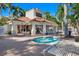 Beautiful pool area surrounded by palm trees and lounge chairs with a cabana at 6083 Bahia Del Mar Cir # 359, St Petersburg, FL 33715