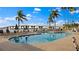 Resort-style pool with ample seating, palm trees, and scenic views of the water and bridge at 6083 Bahia Del Mar Cir # 359, St Petersburg, FL 33715