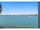 Beautiful water view showcasing waterfront houses and a boat on a sunny day at 6083 Bahia Del Mar Cir # 359, St Petersburg, FL 33715