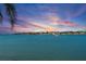 Stunning waterfront view showcases a calm waterway and gorgeous sunset sky overlooking homes in the distance at 6083 Bahia Del Mar Cir # 359, St Petersburg, FL 33715