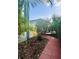 Landscaped walkway of a home leading to a paved patio at 6157 Castleton Hollow Rd, Riverview, FL 33578