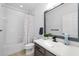 Clean bathroom featuring a sink, toilet, and shower with a colorful polka dot curtain at 6157 Castleton Hollow Rd, Riverview, FL 33578
