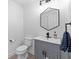 A stylish bathroom features a gray vanity, hexagon mirror, and modern fixtures, offering a touch of elegance at 6157 Castleton Hollow Rd, Riverview, FL 33578
