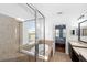 Bathroom showcasing a tub, shower, and double sinks under vanity lighting, with a view to the Primary bedroom at 6157 Castleton Hollow Rd, Riverview, FL 33578