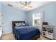 Light blue bedroom with ceiling fan, and a twin bed set. Includes a play kitchen set at 6157 Castleton Hollow Rd, Riverview, FL 33578