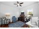 Bright bedroom featuring modern decor, plush seating, and a ceiling fan, creating a serene and inviting atmosphere at 6157 Castleton Hollow Rd, Riverview, FL 33578