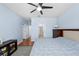 A well-lit bedroom has hard floors and neutral walls, leading to a series of hallway doorways at 6157 Castleton Hollow Rd, Riverview, FL 33578