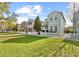 Spacious front yard showcases the home's curb appeal with green grass and neighboring houses at 6157 Castleton Hollow Rd, Riverview, FL 33578