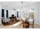 The bright living space includes a modern light fixture, backyard views, and an adjacent dining room, ideal for entertaining at 6157 Castleton Hollow Rd, Riverview, FL 33578