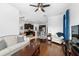 Open-concept living room with view into kitchen, featuring hardwood floors and stylish furniture at 6157 Castleton Hollow Rd, Riverview, FL 33578