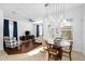 Cozy dining area adjacent to a living room filled with natural light and stylish decor at 6157 Castleton Hollow Rd, Riverview, FL 33578