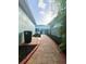Brick-paved walkway between homes, leading to a fenced backyard area at 6157 Castleton Hollow Rd, Riverview, FL 33578