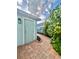 Charming brick walkway leading to a backyard entrance, surrounded by lush greenery at 6157 Castleton Hollow Rd, Riverview, FL 33578