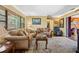 A cozy living room featuring wood floors, a ceiling fan, and natural lighting at 683 Circle E Dr, Largo, FL 33770