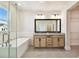 Modern bathroom features a soaking tub, double vanity, and natural light at 7266 Kodiak Ln, Sarasota, FL 34240