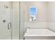 Tiled shower and tub in a bright bathroom, complimented by a large window providing natural light at 7266 Kodiak Ln, Sarasota, FL 34240