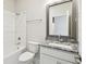 Bathroom featuring a tub and shower, tiled walls, granite countertop, and ample natural light at 7266 Kodiak Ln, Sarasota, FL 34240