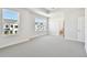 Light filled bedroom with carpet flooring, white walls, and large windows at 7266 Kodiak Ln, Sarasota, FL 34240