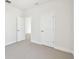 Bright, neutral bedroom with neutral carpeting and an open doorway at 7266 Kodiak Ln, Sarasota, FL 34240