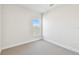 Bright, neutrally decorated bedroom with a window and neutral carpet at 7266 Kodiak Ln, Sarasota, FL 34240