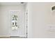 Bright entryway with glass door, light wood floors, and a glimpse of the neighborhood at 7266 Kodiak Ln, Sarasota, FL 34240