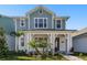 Charming two-story home with a covered front porch and beautiful landscaping, creating great curb appeal at 7266 Kodiak Ln, Sarasota, FL 34240