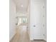 Bright hallway with light wood floors, white walls, and recessed lighting, leading to other rooms at 7266 Kodiak Ln, Sarasota, FL 34240