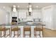 Beautiful kitchen with stainless steel appliances, large island and modern lighting fixtures at 7266 Kodiak Ln, Sarasota, FL 34240
