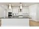 Modern kitchen with white cabinetry, stainless steel appliances, and a large center island, offering ample counter space at 7266 Kodiak Ln, Sarasota, FL 34240