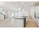 Bright kitchen with a center island, stainless steel dishwasher, and an open layout to the living area at 7266 Kodiak Ln, Sarasota, FL 34240