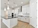 Modern kitchen featuring a center island with stainless steel appliances, white cabinetry, and modern lighting at 7266 Kodiak Ln, Sarasota, FL 34240