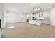 Large living room with an open concept kitchen and luxury vinyl plank flooring at 7266 Kodiak Ln, Sarasota, FL 34240