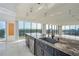 Open kitchen with granite counters, stainless steel appliances, marble floors and stunning view at 7600 Bayshore Dr # 901, Treasure Island, FL 33706