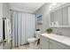 Bathroom featuring gray walls, a shower with curtain, a toilet, and a white sink vanity at 1032 Jadewood Ave, Clearwater, FL 33759