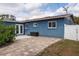 Private backyard featuring a well-maintained paver patio and lush landscaping, perfect for outdoor entertaining at 10754 111Th N Pl, Largo, FL 33778