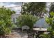 The backyard has mature landscaping, a small patio, and a privacy fence at 10754 111Th N Pl, Largo, FL 33778