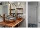 Bathroom featuring dual hammered copper bowl sinks on a wood counter and tile walls at 10754 111Th N Pl, Largo, FL 33778